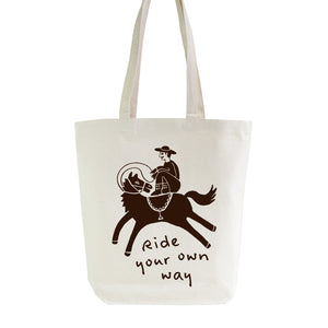 Tote bag with a graphic of a person riding a horse and the text 'Ride your own way' on a white background.