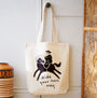 A cotton canvas shopping tote bag with an illustration of a cowboy riding a horse and the phrase 'ride your own way' printed on the front.